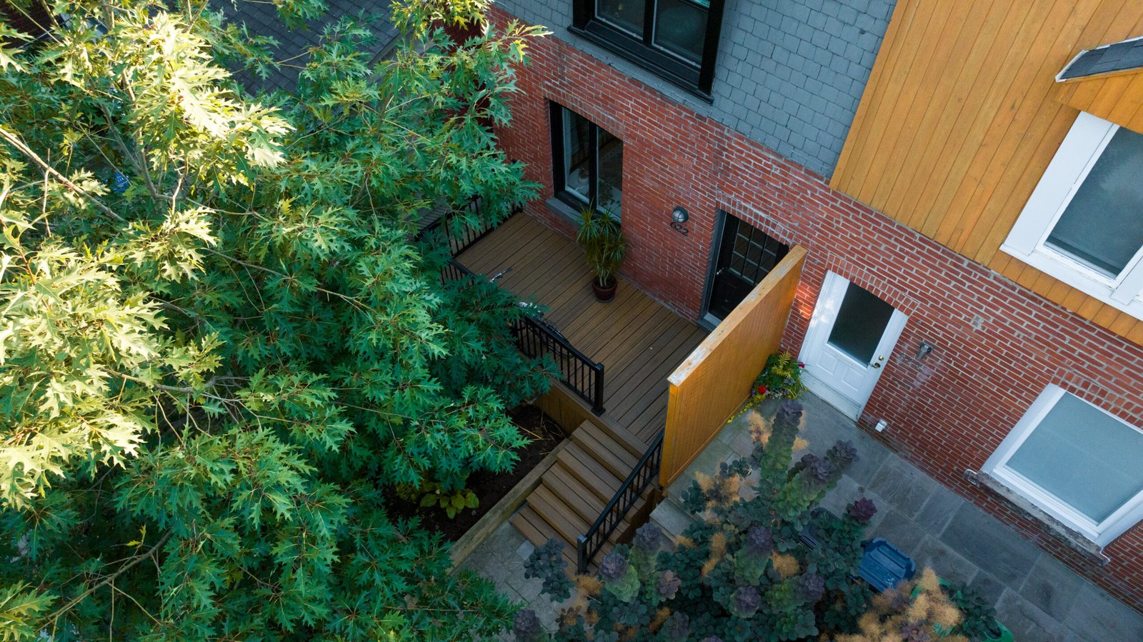Aerial view of the Bedford Park backyard: deck, privacy screen and stone patio