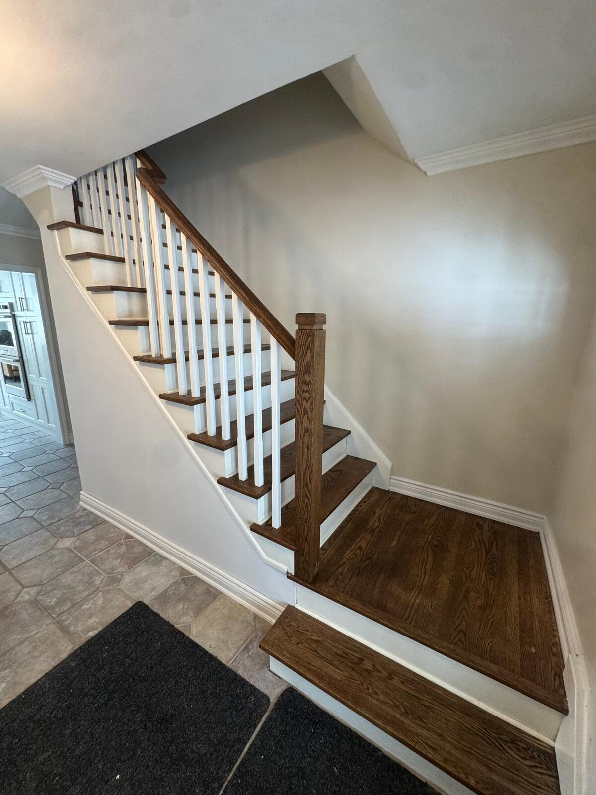 Refinished oak staircase with stained treads and painted trim